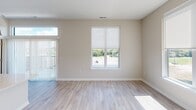 This contemporary apartment, located at 900 3rd St SE in Cedar Rapids, Iowa, offers 1320 square feet of thoughtfully designed living space. The open floor plan seamlessly integrates the kitchen, living, and dining areas, creating a spacious and airy atmosphere. The kitchen boasts sleek white cabinetry, stainless steel appliances, and a large island with pendant lighting, perfect for casual dining or entertaining.

Both bedrooms are generously sized, with the primary bedroom measuring 140 square feet. Large windows in the bedrooms and living areas flood the space with natural light and offer city views. The apartment features three well-appointed bathrooms, ensuring convenience for residents and guests alike.

Throughout the home, neutral tones and modern finishes create a clean, fresh aesthetic. Plush carpeting in the bedrooms provides comfort underfoot, while durable wood-look flooring in the main living areas adds warmth and easy maintenance. Ample closet space, including walk-in closets with wire shelving systems, offers abundant storage options.

The apartment's single-floor layout and modern amenities, such as ceiling fans and recessed lighting, contribute to its overall comfort and functionality. This urban dwelling combines style and practicality, making it an ideal home for those seeking a contemporary living experience in the heart of Cedar Rapids.