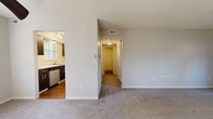 Located at 6110 Fireside Dr in Centerville, OH, this one-bedroom, one-bathroom unit offers a functional and comfortable single-floor layout. The kitchen is well-equipped with dark espresso cabinetry, light countertops, a stainless steel dishwasher, electric range, and refrigerator, all set over warm hardwood-style flooring. A window allows natural light to brighten the space. The living room is carpeted and generously sized, featuring a ceiling fan and a sliding glass door that opens directly to a private patio with outdoor views. An adjacent dining area connects seamlessly to both the kitchen and living room, creating an open, cohesive flow. A hallway leads to the private bedroom, which features plush carpeting and two closets—including a walk-in with built-in shelving—offering ample storage. The full bathroom includes a single-sink vanity with dark cabinetry, a combined tub and shower, and hardwood-style flooring. Additional storage is available through five closets distributed throughout the unit, along with a dedicated utility room. The overall design is clean and neutral, with light gray walls, white trim, and consistent finishes that create a bright and move-in-ready atmosphere.