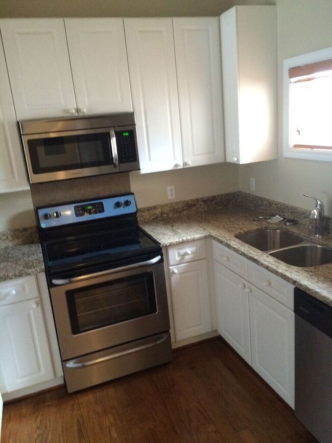 Kitchen has a Refrigerator, Microwave, Oven, Dishwasher & Disposal - 314 S Cedar St