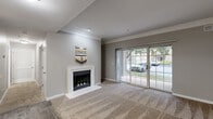 Located at 1121 Prairie Pt in O'Fallon, MO, this 2-bedroom, 1-bathroom residence offers a practical and comfortable single-floor layout. The living room serves as the heart of the home, highlighted by a white-framed fireplace, crown molding, plush carpeting, and a sliding glass door that fills the space with natural light and provides views of the surrounding greenery. Adjacent to the living area, a dining space with wood-look flooring and a pendant light fixture connects seamlessly to the galley-style kitchen, which features warm wood cabinetry, granite-style countertops, stainless steel and black appliances, and durable wood-look tile flooring. A central hallway leads to both bedrooms, each finished with soft carpeting. The primary bedroom is generously sized and the second bedroom includes a ceiling fan and a window overlooking the exterior. The full bathroom offers a wood-vanity with a granite-style countertop, overhead cabinetry, a tub-shower combination, and wood-look tile flooring. A dedicated laundry room with built-in shelving and an in-unit washer adds everyday convenience. Neutral gray walls and consistent finishes throughout lend the space a cohesive, move-in-ready feel.