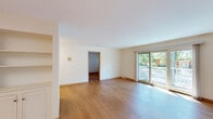 Located at 24 Heritage Cir Unit 6 in Madison, WI, this well-appointed 3-bedroom, 2-bathroom single-floor residence offers a thoughtfully designed layout across a generously sized floor plan. The bright living room features light hardwood-style flooring and large sliding glass doors that open to a private balcony, flooding the space with natural light and providing views of the surrounding tree-lined grounds. The updated kitchen is equipped with stainless steel appliances — including a range, over-the-range microwave, dishwasher, and refrigerator — complemented by white cabinetry, white quartz countertops, and warm wood flooring that extends into the hallway. The spacious primary bedroom includes dual closets and a large window overlooking the greenery outside. Two additional bedrooms feature hardwood-style flooring and bright windows, offering flexibility for various uses. The updated full bathroom showcases marble-look tile flooring, subway tile wainscoting, and a sleek vanity with a stone countertop, while the second bathroom includes a full tub-shower combination with white tile surround. A dedicated closet and hallway complete the functional layout of this inviting Madison residence.