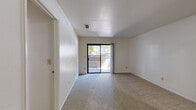 Located at 3200 Truxel Rd in Sacramento, CA, this one-bedroom, one-bathroom unit offers a thoughtfully organized single-floor layout. The living room is carpeted and bathed in natural light, with a sliding glass door that opens directly onto a private patio, providing outdoor access and pleasant views of the surrounding area. A separate dining room connects the living space to the kitchen, creating a functional flow throughout the common areas. The kitchen is efficiently arranged in a galley style, featuring gray cabinetry, laminate countertops, wood-look vinyl flooring, and white appliances including a range and refrigerator. The spacious bedroom offers generous square footage, a large window with outdoor views, soft carpet underfoot, and ample storage supported by multiple closets throughout the unit. A ceiling fan adds comfort to one of the additional rooms. The bathroom includes a full tub-shower combo with clean white fixtures and wood-look flooring. Textured ceilings are featured throughout the unit, and the neutral white walls create a bright, clean backdrop. With four closets total, storage is a notable strength of this well-structured Sacramento home.