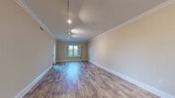 Located at 885 Woodside Rd in Redwood City, California, this well-appointed single-floor residence offers a thoughtfully designed layout with refined finishes throughout. The open-concept living area is anchored by light wood-tone flooring, elegant crown molding, and track lighting, creating a bright and welcoming atmosphere. A bay window allows natural light to pour in, further enhancing the spacious feel of the main living space.

The kitchen is a standout feature, showcasing rich warm-toned wood cabinetry with shaker-style doors and brushed nickel hardware, complemented by granite countertops and a coordinating stone tile backsplash with under-cabinet lighting. Stainless steel appliances — including a gas range, built-in microwave, dishwasher, and refrigerator — complete the well-equipped culinary space. A breakfast bar provides convenient additional counter space.

The bedrooms feature plush carpeting and generous closet space, with the primary bedroom offering direct access to a private balcony overlooking lush greenery. The primary bathroom includes a dual-sink vanity with warm wood cabinetry, a separate water closet, and a glass-enclosed shower with tile surround. A secondary bathroom mirrors the same cohesive design with tile flooring and a single vanity. Crown molding and neutral tones carry throughout, lending the entire residence a polished, consistent aesthetic.