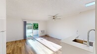 This 330 square foot apartment in Newport Beach offers a thoughtful layout that maximizes every inch of space. The open-concept design creates a seamless flow between the living area and kitchen, making the space feel larger than its actual footprint. The living room features warm wood flooring and is bathed in natural light from a large sliding glass door, which leads to a private balcony offering a touch of outdoor living.

The kitchen, while compact, is efficiently designed with modern appliances and light-colored cabinetry that contributes to the apartment's bright and airy feel. A breakfast bar provides additional counter space and casual dining options.

The bathroom showcases contemporary fixtures and finishes, including a sleek vanity and a combination tub-shower. Ample storage solutions are integrated throughout the apartment, with built-in closets and cabinets helping to maintain a clutter-free environment.

Comfort features include a ceiling fan in the main living area and a wall-mounted air conditioning unit, ensuring a pleasant indoor climate year-round. The apartment's neutral color palette and clean lines create a versatile canvas for various decorating styles, appealing to those seeking a modern, low-maintenance living space in a desirable Newport Beach location.
