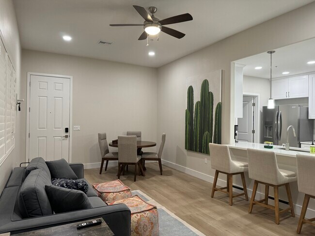 Living area with couch, four-seating dining table, beautiful vinyl floors, ceiling fan - 2040 E River Rd