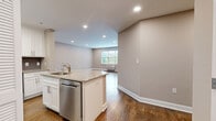Located at 29 Linden St in Hackensack, NJ, this well-appointed 2-bedroom, 2-bathroom residence offers a thoughtfully designed single-floor layout. Rich hardwood flooring flows throughout the living areas and bedrooms, complemented by neutral gray walls and bright white trim that create a clean, contemporary aesthetic.

The open kitchen is outfitted with white shaker-style cabinetry, granite countertops, a subway tile backsplash, and a full suite of stainless steel appliances including a refrigerator, range, and microwave. A stacked washer and dryer unit is conveniently integrated within the kitchen area. The combined kitchen and living room offers a generous, versatile gathering space with ceiling fan and natural light from a window overlooking greenery outside.

The spacious primary bedroom features large windows with exterior views, a ceiling fan, and in-wall climate control. It is accompanied by a well-organized walk-in closet with custom shelving and hanging systems on multiple walls. The second bedroom is equally comfortable, with recessed lighting and hardwood floors. Both bathrooms are finished with large-format beige tile, soaking tub-shower combos with tile surrounds, dark espresso vanities, and white countertops, delivering a clean and modern feel throughout.