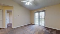Located at 2389 Bayside Dr in Columbus, Ohio, this single-story unit offers a well-organized layout designed for comfortable everyday living. The open-concept entry area transitions seamlessly into the main living space, where plush carpeting and neutral warm-toned walls create an inviting atmosphere. Vaulted ceilings in the living area add a sense of spaciousness, complemented by a ceiling fan with integrated lighting. A sliding glass door fitted with vertical blinds provides access to an outdoor area and allows natural light to fill the room.

The kitchen is efficiently designed in a galley-style configuration, featuring rich dark wood cabinetry, granite-look countertops, wood-look flooring, and white appliances including a range, refrigerator, microwave, and dishwasher. A raised breakfast bar separates the kitchen from the living area, enhancing the open feel of the shared space.

The bedrooms are carpeted and receive natural light through windows with views of the surrounding neighborhood. Each room includes standard interior doors with clean white panel detailing. The bathroom is finished with dark wood vanity cabinetry, granite countertops, wood-look tile flooring, a large mirror, and a full soaking tub with shower.