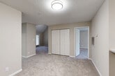 Located at 2400 Whitehall Estates Dr in Charlotte, NC, this single-floor, 2-bedroom, 2-bathroom residence offers a thoughtfully designed layout with a comfortable and functional living environment. The open-concept living and dining area flows seamlessly into the kitchen, which is equipped with stainless steel appliances, white shaker cabinets, granite-style countertops, a classic subway tile backsplash, and a peninsula island with additional counter space. Wood-look flooring runs through the kitchen and main areas, while plush carpet adds warmth to the living and bedroom spaces. The generously sized primary bedroom features a dramatic vaulted ceiling that creates an airy, open feel, complemented by a large bay window that invites natural light and outdoor views. A second bedroom also benefits from ample natural light and a spacious closet. Both bathrooms are finished with granite-style vanity tops, white cabinetry, and tiled tub-shower combinations with wood-look flooring. Additional highlights include four closets for abundant storage, a dedicated laundry area, a utility room, and a private balcony with a classic wood deck—ideal for outdoor relaxation. Neutral tones throughout create a clean, move-in-ready aesthetic.
