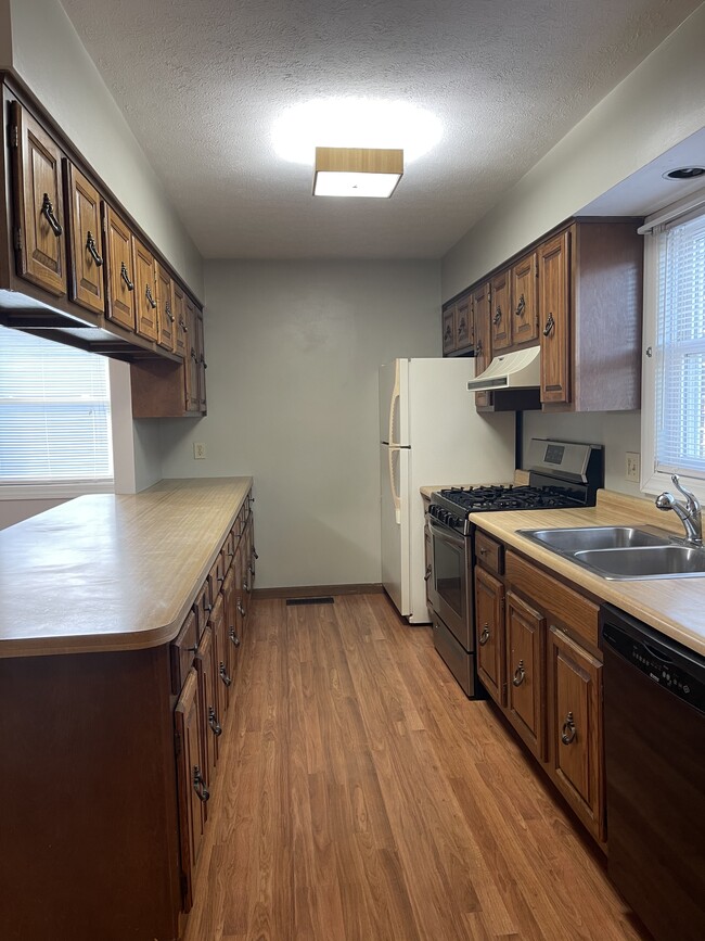 Kitchen with gas stove, refrigerator and dishwasher. - 120 Tennis Center Dr