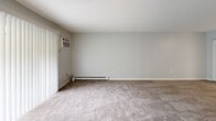 Located at 65 Carriage Way Dr in Fitchburg, MA, this one-bedroom, one-bathroom residence offers a comfortable and functional layout across a single floor. The living room is a welcoming space featuring soft carpeting, a baseboard heating system, a wall-mounted air conditioning unit, and a sliding glass door that opens to a private balcony overlooking lush, mature greenery — filling the room with natural light and peaceful outdoor views. The kitchen is well-equipped with warm honey-toned cabinetry, dark granite countertops, stainless steel appliances including an electric range, dishwasher, and refrigerator, along with tile-style flooring and a closet for added pantry storage. The spacious bedroom is carpeted and bathed in natural light from a large window, and features a wide double-door closet with louvered panels, providing ample storage. The full bathroom includes a clean, full-sized tub and shower combination. Throughout the residence, four closets offer exceptional storage capacity. Neutral gray walls and consistent finishes create a cohesive, move-in-ready aesthetic throughout the home.