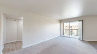 Located at 17730 Lassen St in the Northridge neighborhood of Los Angeles, this well-appointed 2-bedroom, 3-bathroom residence offers a comfortable and functional single-floor layout. The living area is bright and open, featuring plush carpeting and a large sliding glass door that opens to a private balcony, inviting ample natural light and outdoor views. The kitchen is outfitted with white cabinetry, speckled quartz-style countertops, a gas range, and an over-the-range microwave, providing a clean and efficient cooking space. Both bedrooms are generously sized and carpeted, offering a cozy atmosphere. The primary bedroom includes mirrored sliding closet doors, adding a sense of depth and storage convenience. The bathrooms are finished with light wood-style vinyl flooring, white vanities with stone countertops, and a shower-tub combination, maintaining a clean and cohesive aesthetic throughout. Two hallways connect the rooms efficiently, contributing to a smooth and practical flow. The neutral color palette of whites and soft beiges used throughout the space creates a bright, airy ambiance that is easy to personalize.