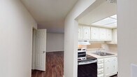 This 870 square foot apartment in Summit West, unit 20C-B1, offers a well-designed living space with two bedrooms and one bathroom. The interior showcases a cohesive design with warm, wood-look flooring throughout, creating a modern and inviting atmosphere. The primary bedroom, measuring 150 square feet, provides ample space for comfortable living.

The kitchen is a highlight, featuring bright white cabinetry, stainless steel appliances, and a skylight that bathes the space in natural light. It's equipped with a dishwasher and a full-size refrigerator, making it both functional and aesthetically pleasing.

Both bedrooms are generously sized, with large windows that allow for plenty of natural light. The bathroom, while compact, is efficiently designed with a shower/tub combination and safety grab bars. Storage is abundant throughout the apartment, with a walk-in closet and additional built-in shelving in the hallway.

The open floor plan creates a sense of spaciousness, with smooth transitions between rooms. The neutral color palette of the walls provides a blank canvas for personalization. Overall, this apartment offers a blend of comfort, functionality, and modern design elements.