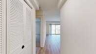 Located at 5764 Stevens Forest Rd in Columbia, MD, this one-bedroom, one-bathroom residence offers a thoughtfully designed single-level layout. The living room is bright and inviting, featuring light hardwood-style flooring, crisp white walls, and a ceiling fan with integrated lighting. A sliding glass door opens to a private balcony, allowing natural light to fill the space and providing outdoor views. The kitchen is well-equipped with stainless steel appliances—including a gas range, dishwasher, and full-size refrigerator—complemented by white shaker-style cabinetry with matte black hardware, granite-look countertops, and a classic subway tile backsplash. The bedroom offers a comfortable retreat with plush wall-to-wall carpeting, a window with exterior views, and ample wall space, along with access to a dedicated closet featuring louvered doors. The bathroom includes a full tub-shower combination with white tile surround and dark accent hardware. Throughout the residence, a clean, neutral palette and consistent finishes create a cohesive and move-in-ready atmosphere suited for everyday living.