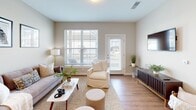 This meticulously designed 600 square foot apartment maximizes space and functionality without compromising on style. The open-concept layout seamlessly integrates the kitchen, living, and dining areas, creating a sense of spaciousness. The kitchen boasts sleek white cabinetry, stainless steel appliances, and a granite countertop with a breakfast bar, perfect for casual dining or entertaining.

The living area is bathed in natural light from large windows and features a comfortable seating arrangement, ideal for relaxation or socializing. The bedroom, measuring 140 square feet, offers a cozy retreat with plush carpeting and a large window. The bathroom is elegantly appointed with a modern vanity, granite countertop, and a spacious walk-in shower.

Throughout the apartment, warm wood-look flooring adds a touch of warmth and sophistication. Thoughtful details such as pendant lighting, framed artwork, and strategically placed greenery enhance the overall ambiance. The efficient floor plan ensures every square foot is utilized effectively, making this apartment an excellent choice for those seeking a contemporary urban living space.
