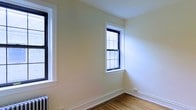 Located at 58 N Lansdowne Avenue in Lansdowne, PA, this single-floor space reflects classic residential character with thoughtful architectural details throughout. The interior features warm hardwood flooring that adds a sense of continuity and timeless appeal across the space. Crisp white walls and clean, bright trim work create a fresh, well-maintained aesthetic that feels both inviting and functional. Natural light plays a prominent role in defining the ambiance, with multiple multi-pane windows framed in bold black accents allowing generous daylight to fill the rooms. The windows are complemented by detailed white window casings and substantial baseboards, highlighting the traditional craftsmanship of the space. A classic radiator is also present, indicative of a well-established heating system suited for the Pennsylvania climate. The overall atmosphere is clean, bright, and airy, with a neutral palette that offers flexibility for a variety of uses. The combination of natural materials, period-appropriate details, and abundant natural light makes this space a characterful and practical setting at an accessible Lansdowne address.