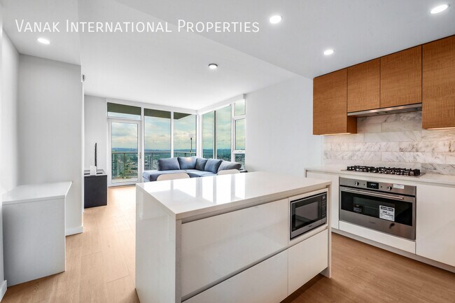 Photo du bâtiment - Luxury 2 Bed + Den Corner Home on the 52nd Floor at Gilmore Place