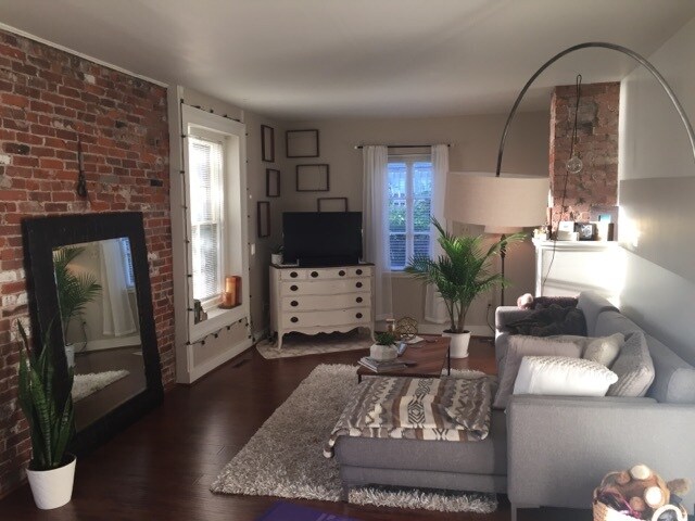living room with exposed brick - 640 Quinnipiac Ave