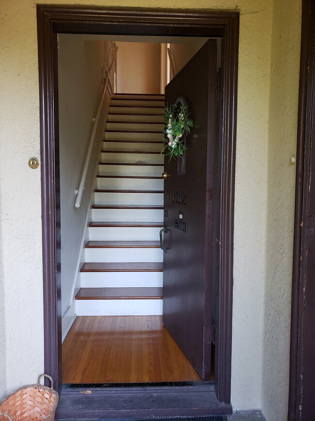 Front door leads up to unit. There's a button at the top of the stairs to buzz visitors in. - 1112 Maple St