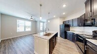 Located in Dallas, TX, this well-designed single-story home offers four bedrooms, two bathrooms, and a thoughtful layout ideal for comfortable living. The open-concept kitchen, dining, and living area serves as the heart of the home, featuring a central island with a granite countertop and undermount sink, dark espresso cabinetry, pendant lighting, and black appliances. The living area benefits from multiple windows that allow natural light to fill the space, complemented by a ceiling fan overhead. Luxury vinyl plank flooring runs throughout the main living areas and bedrooms, adding warmth and continuity. The bedrooms are generously sized, each featuring neutral tones, natural light from windowed walls with blinds, and convenient access to one of five closets — including a spacious walk-in with wire shelving. The primary bathroom is appointed with a dual-sink vanity, granite countertops, dark cabinetry with chrome hardware, a large mirror, and clean tile flooring. A dedicated laundry room, entrance foyer, and connecting hallway round out the functional layout. Recessed lighting throughout the home ensures a bright, modern ambiance in every room.