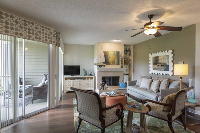 Bright Living Room with Oversized Windows - Golf Brook Apartments