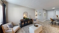 Located at 5319 Nolensville Pike in Nashville, TN, this 2-bedroom, 1-bathroom unit offers a well-organized single-floor layout designed for comfortable everyday living. The living room is a welcoming, generously proportioned space featuring light wood-style flooring, soft neutral walls, a textured ceiling, and a large window dressed with blinds and dark curtain panels that allow for ample natural light. The open sightlines from the living area extend toward the kitchen, enhancing the sense of space throughout.

The kitchen is equipped with white shaker-style cabinetry, marble-look countertops, a black electric range with overhead ventilation, and a dishwasher — all set against light flooring and neutral walls for a clean, functional aesthetic.

The primary bedroom is a comfortable retreat with a sliding door closet offering built-in hanging storage, light wood-style flooring, soft gray walls, and a well-sized window that brings in natural light. The second bedroom shares a similar neutral palette and bright character.

The bathroom features a full tub-shower combination with white surround panels, brushed nickel fixtures, and light flooring, providing a clean and practical finish. Throughout the unit, consistent flooring, neutral tones, and natural light create a cohesive and inviting atmosphere.