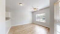 This single-story residence in Horn Lake, Mississippi offers a thoughtfully designed layout that maximizes comfort and functionality. Light-toned wood-style flooring flows throughout the main living areas, complemented by neutral gray walls and textured ceilings that create a clean, cohesive aesthetic. The spacious living room features a ceiling fan with light fixture and a large window fitted with blinds, inviting ample natural light. A dedicated entryway hallway provides a welcoming transition into the home. The kitchen is well-equipped with white raised-panel cabinetry, light quartz-style countertops, black appliances including an electric range, over-the-range microwave, and a stainless steel refrigerator, along with a pantry for additional storage. The bedroom is carpeted for warmth and comfort, complete with a ceiling fan and access to a generously sized walk-in closet featuring wire shelving on multiple walls. A second closet provides even more storage. The full bathroom includes a tub/shower combo, a white vanity with mirror, and chrome fixtures. Additional features include an in-unit laundry area and a private balcony, rounding out this practical and comfortable residence.