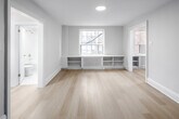 This 430 square foot condo, located at 262 Jarvis St in Toronto, offers a thoughtful blend of comfort and efficiency. The space is intelligently designed to maximize functionality within its compact footprint. The single bedroom, spanning 220 square feet, provides ample space for rest and relaxation.

The living area is characterized by its bright, airy ambiance, courtesy of large windows that flood the space with natural light. A standout feature is the built-in shelving and storage beneath the window, offering both practicality and aesthetic appeal. The room's neutral color palette and light hardwood flooring create a sense of spaciousness and modernity.

The kitchen is a testament to contemporary design, featuring sleek white cabinetry, stainless steel appliances, and a gas stove. The L-shaped layout optimizes counter space, while the undermount sink adds a touch of elegance. 

The bathroom, though compact, is well-appointed with a modern white suite, including a bathtub-shower combination. Marble-look tiling adds a luxurious touch to the space.

Throughout the condo, recessed lighting provides even illumination, enhancing the overall sense of space. The open-concept layout facilitates easy movement between rooms, making the most of the available square footage. This condo represents an ideal urban living solution, balancing comfort with efficiency in a prime Toronto location.