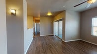 Located at 1325 Northwestern Dr in El Paso, TX, this single-floor unit offers a well-designed layout with consistent finishes throughout. The living area features durable wood-look plank flooring, neutral-toned walls, a ceiling fan, and a sliding glass door that opens to an outdoor patio, filling the space with natural light and providing easy outdoor access. A second sliding glass door is visible from another area of the living space, further enhancing the connection to the outdoors.

The kitchen is equipped with rich, dark cherry wood cabinetry, light countertops, tile flooring, and stainless steel appliances including a gas range and built-in microwave, offering both style and functionality.

The bedrooms continue the wood-look flooring and feature arched panel doors, neutral walls, and windows fitted with blinds that allow for natural light while maintaining privacy. Ceiling fans are present in multiple rooms for added comfort.

The bathrooms are finished with large-format tile flooring. The primary bathroom includes a double-sink vanity with dark wood cabinetry, framed mirrors, and a tub-shower combination with tile surround. A secondary bathroom offers a clean, all-white tub-shower unit with additional storage shelving. The overall aesthetic is clean, functional, and move-in ready.