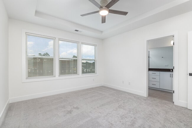 Primary bedroom with tray ceiling, fan and walk in closet - 514 Billingshurst Way