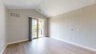 Located at 40 Traders Row in Salem, MA, this well-appointed 2-bedroom, 2-bathroom residence offers a thoughtfully designed single-floor layout. The primary bedroom stands out with soaring vaulted ceilings, light hardwood flooring, and sliding glass doors that open onto a private balcony with outdoor views. The second bedroom features plush carpeting and a large window that fills the room with natural light and views of surrounding greenery. The kitchen is equipped with stainless steel appliances, including a refrigerator, range, and microwave, complemented by granite countertop surfaces, white cabinetry, and a peninsula with pendant lighting — ideal for casual dining or entertaining. Light hardwood flooring extends through the main living areas, adding warmth and continuity throughout. The two bathrooms are finished with neutral tile flooring; one features a granite-topped vanity with brushed nickel fixtures, while the other includes a full tub and shower combination. Soft, neutral wall tones throughout create a clean and calm ambiance. A dedicated closet and hallway complete the functional layout of this comfortable Salem residence.