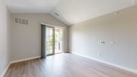 Located at 40 Traders Row in Salem, MA, this well-appointed 2-bedroom, 2-bathroom residence offers a thoughtfully designed single-floor layout. The primary bedroom stands out with soaring vaulted ceilings, light hardwood flooring, and sliding glass doors that open onto a private balcony with outdoor views. The second bedroom features plush carpeting and a large window that fills the room with natural light and views of surrounding greenery. The kitchen is equipped with stainless steel appliances, including a refrigerator, range, and microwave, complemented by granite countertop surfaces, white cabinetry, and a peninsula with pendant lighting — ideal for casual dining or entertaining. Light hardwood flooring extends through the main living areas, adding warmth and continuity throughout. The two bathrooms are finished with neutral tile flooring; one features a granite-topped vanity with brushed nickel fixtures, while the other includes a full tub and shower combination. Soft, neutral wall tones throughout create a clean and calm ambiance. A dedicated closet and hallway complete the functional layout of this comfortable Salem residence.
