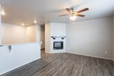 Located at 13407 Indiana Ave in Lubbock, Texas, this single-story home offers a clean, modern interior designed for comfortable living. The open living area features durable wood-look flooring and a sleek corner fireplace with a dark mantel, creating a warm and inviting focal point in the room. A ceiling fan adds to the comfort of the space. The kitchen is well-appointed with rich dark cabinetry, light granite-style countertops, generous counter space, and a full suite of black appliances including a range, over-the-range microwave, and refrigerator. A raised bar counter with seating overhang connects the kitchen to the living area, enhancing the open-concept flow. Bedrooms are carpeted for comfort, with one room featuring French doors that open to a private outdoor balcony or patio, allowing natural light to fill the space. Walk-in closet space provides ample storage. The bathrooms are finished with dark wood cabinetry, light countertops, and wood-look flooring, with one bathroom offering a tub/shower combination. Throughout the home, neutral tones and consistent finishes create a cohesive, move-in-ready aesthetic suited for a variety of lifestyles.