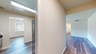 This well-designed 760 square foot apartment offers a perfect blend of comfort and functionality. The spacious bedroom, measuring 170 square feet, provides ample space for relaxation and storage. The open-concept living area seamlessly integrates the living room and kitchen, creating a welcoming atmosphere for entertaining or everyday living. The kitchen boasts modern appliances, including a stainless steel refrigerator, dishwasher, and microwave, complemented by sleek cabinetry and a tiled backsplash. The bathroom features a full-size tub with shower and contemporary fixtures. Large windows throughout allow for abundant natural light, while the sliding glass door in the living room provides access to a private outdoor space. The apartment also includes in-unit laundry facilities with a washer and dryer. Flooring varies between plush carpeting in the bedroom and durable wood-look laminate in the main living areas, adding to the overall aesthetic appeal of this thoughtfully designed living space.
