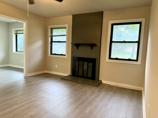Living room has lots of light and a fireplace. - 8274 Lifford Pl