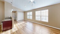Located at 4720 Transit Rd in Depew, NY, this single-floor, one-bedroom, one-bathroom unit offers a thoughtfully designed layout with modern finishes throughout. The combined kitchen and living room forms the heart of the home, where large windows flood the space with natural light, highlighting the warm hardwood-style flooring and vaulted ceiling with a ceiling fan. The galley-style kitchen is outfitted with rich cherry wood cabinetry, granite countertops, and a full suite of stainless steel appliances, including a range, microwave, and refrigerator. The open flow into the living area creates a spacious, airy feel ideal for both everyday living and entertaining. The bedroom is generously sized, featuring plush carpeting, a ceiling fan with light fixture, a window with outdoor views, and a closet. The bathroom offers wood-look tile flooring, a dark-toned vanity with granite countertop, and a window for natural ventilation. A dedicated closet provides additional storage. The unit also includes an attached garage with a concrete floor and automatic opener, offering secure and convenient parking or additional storage space.