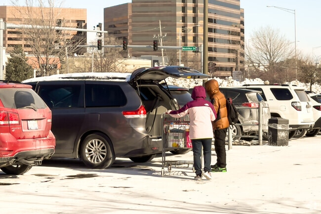 Bundled up residents loading their groceries into the car.