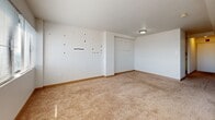 Located at 301 Chestnut St in downtown Harrisburg, PA, this two-bedroom, one-bathroom unit offers a practical and well-organized single-floor layout. The living room is a generously carpeted space featuring large windows with horizontal blinds that allow natural light to fill the room, creating a bright and open atmosphere. The kitchen is efficiently designed with white cabinetry — both upper and lower — providing ample storage, complemented by light countertops, a stainless steel sink, a white range, and a dishwasher. The tile flooring adds a clean, functional finish to the space. The primary bedroom is a comfortable, carpeted room featuring a wide sliding-door closet, a window that brings in natural light, and clean white walls. The second bedroom is similarly carpeted and bright, with a window and a visible HVAC vent, making it a versatile space. Three hallways connect the rooms, providing smooth circulation throughout the unit. The full bathroom features a classic white tiled tub-shower combination with chrome fixtures, maintaining a clean and simple aesthetic. Throughout the unit, neutral tones, carpet flooring in living areas, and consistent white walls contribute to a cohesive and move-in-ready feel.