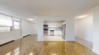 Located on the 9th floor at 55 Park Street East in Mississauga, this well-appointed 3-bedroom, 1-bathroom unit offers a functional and comfortable layout across a single floor. The open living room is a standout space, featuring gleaming parquet hardwood flooring, large windows that invite natural light, and views of the surrounding neighbourhood. A baseboard heating system runs throughout, ensuring year-round comfort.

The kitchen is thoughtfully updated with crisp white shaker cabinetry, a grey subway tile backsplash, grey countertops, and a full suite of stainless steel appliances including a refrigerator, electric range, microwave, and dishwasher. Light tile flooring and track lighting complete the clean, modern aesthetic.

The three bedrooms each feature the same warm parquet flooring and windows with outdoor views. The generously sized primary bedroom includes mirrored sliding closet doors, adding a sense of depth and light. The additional bedrooms are well-proportioned and bright.

The bathroom is finished with classic white subway tile surrounding a full soaker tub, paired with chrome fixtures for a clean, timeless look. A dedicated hallway and closet space round out this practical and move-in-ready unit in the heart of Mississauga.