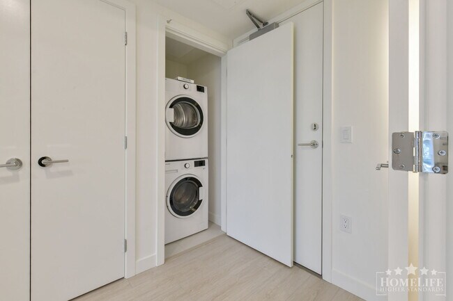 Photo du bâtiment - Modern 1-Bedroom Condo at The Flamingo. Brand-New, Bright, and Steps to Future Shops & Restaurants