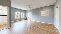 Located at 601 N Rossmore Ave in the desirable Larchmont Village neighborhood of Los Angeles, this single-floor unit offers a well-designed layout that maximizes every inch of its compact footprint. The open living area is finished with warm wood-tone luxury vinyl plank flooring that runs throughout the entire space, complemented by soft gray walls and crisp white trim. Recessed lighting and a ceiling fan keep the living room bright and comfortable, while large windows allow natural light to fill the room and provide views of the surrounding neighborhood. The galley-style kitchen is thoughtfully appointed with white shaker cabinets, open shelving, light quartz countertops, a stainless steel double sink, and white gas range and refrigerator. A ceiling fan overhead adds airflow, and a window at the end of the kitchen brings in additional natural light. The bathroom showcases a classic aesthetic with white subway tiles accented by a bold navy border stripe, a white vanity, a full soaking tub, and wood-tone flooring that ties seamlessly into the rest of the unit. Clean lines and updated fixtures throughout give this space a fresh, move-in-ready feel in one of Los Angeles' most walkable and vibrant neighborhoods.
