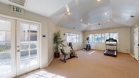 Imagine stepping into your very own private fitness sanctuary, where every day is an opportunity to become the best version of yourself. This exceptional 400 square foot space is more than just a room; it's a gateway to a healthier, more vibrant you. Bathed in natural light streaming through expansive windows, this haven of wellness offers an inspiring atmosphere that will energize your workouts and fuel your motivation.

The thoughtfully designed layout accommodates a variety of exercise equipment, allowing you to create a personalized fitness regimen tailored to your goals. High ceilings add to the sense of spaciousness, while recessed lighting provides a soft, ambient glow for early morning or evening sessions. The durable carpeting offers comfort underfoot and helps absorb sound, creating a peaceful environment for your workouts.

Step outside through the French doors to refresh and recharge, bringing the outdoors into your fitness routine. The neutral color palette and clean lines create a calming backdrop, allowing you to focus on your wellness journey without distraction. With ample wall space, you can easily add mirrors or motivational artwork to further personalize your space.

This isn't just a room; it's an investment in your health and happiness. Whether you're an experienced fitness enthusiast or just beginning your wellness journey, this space offers the perfect setting to transform your body and mind. Embrace the lifestyle you've always dreamed of – your personal oasis of health and vitality awaits.