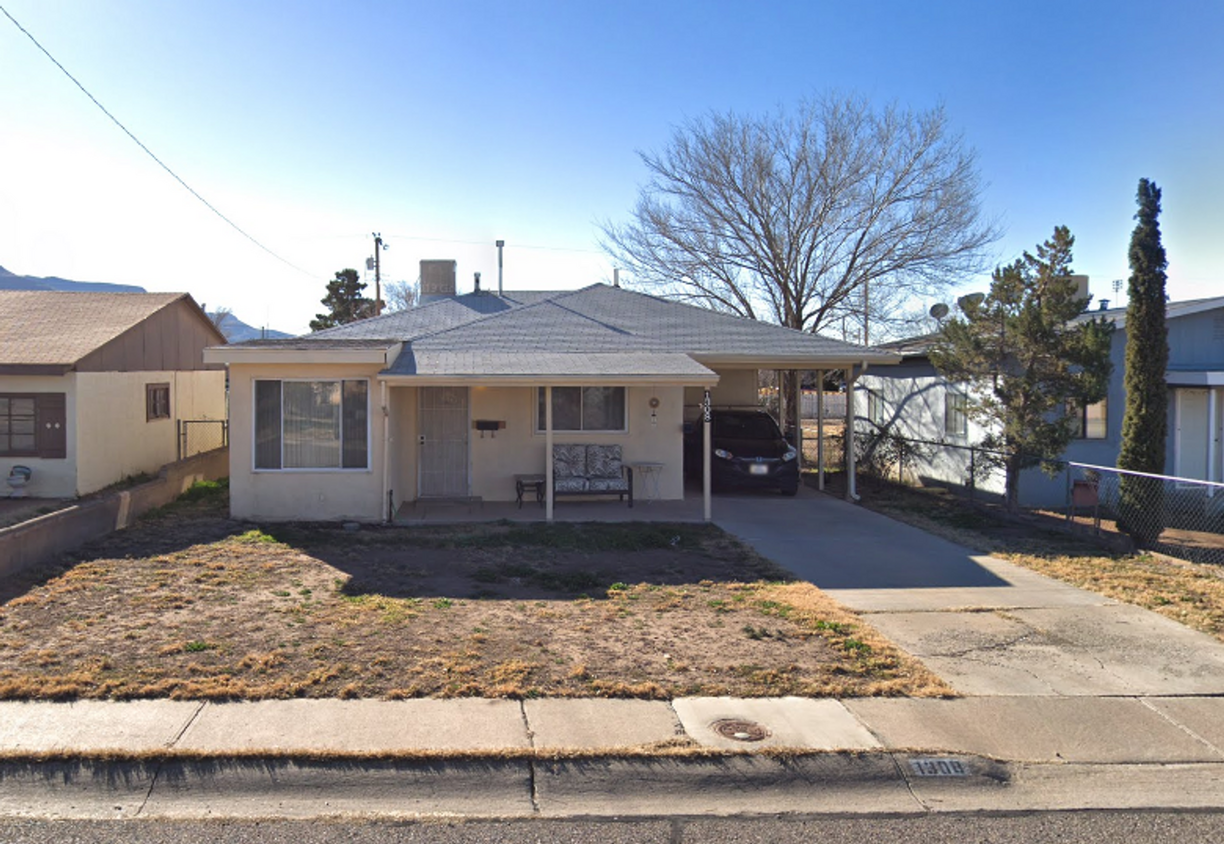 Primary Photo - Property with a carport and laundry.