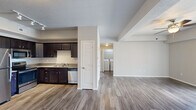 Located at 1003 Bluegrass Cir in Cedar Falls, Iowa, this single-floor, 3-bedroom, 2-bathroom unit offers a well-organized and functional layout. The open kitchen and living area form the heart of the home, with the kitchen showcasing rich dark cabinetry, light countertops, and a full suite of stainless steel appliances including a refrigerator, range, microwave, and dishwasher. Hardwood-style flooring runs throughout the main living areas, adding warmth and continuity to the space. The living room is bright and airy, featuring a ceiling fan and sliding glass doors that open to a private balcony with outdoor views — an inviting space for relaxing or entertaining. A dedicated laundry area with washer and dryer hookups adds everyday convenience. The three bedrooms are carpeted for comfort, with the primary bedroom offering a generous footprint and a window with pleasant neighborhood views. The two bathrooms are clean and practical — one features a walk-in shower, while the other includes a full tub-shower combination, both with wood-style flooring and vanity storage. A closet rounds out the layout, providing additional storage. The overall ambiance is neutral, clean, and move-in ready.
