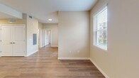 Located at 2203 N University Dr in Pembroke Pines, FL, this one-bedroom, one-bathroom unit offers a thoughtfully designed layout that maximizes every square foot of its compact footprint. The open-concept kitchen and living area form the heart of the home, where warm wood-style flooring flows continuously underfoot. The kitchen is well-appointed with dark walnut-toned cabinetry, white countertops, a peninsula with pendant lighting above, and a full suite of stainless steel appliances including a refrigerator, range, microwave, and dishwasher — ideal for everyday cooking and entertaining.

The living area is bright and airy, with large windows dressed in horizontal blinds that invite natural light while offering privacy. A ceiling fan adds comfort to the space. The bedroom is generously sized for the overall floor plan, featuring dual windows with outdoor views, a ceiling fan, and warm neutral walls that create a calm retreat. A dedicated closet provides practical storage.

The bathroom is clean and functional, finished with large-format tile flooring, a dark wood vanity with a white countertop, a framed mirror, and vanity lighting. Throughout the unit, the warm beige wall tones and consistent wood-style flooring tie the space together cohesively, creating a modern and welcoming atmosphere.