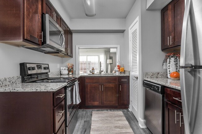 Kitchen with Granite Countertops and Stainless Steel Appliances - Jamestown at St. Matthews Apartments