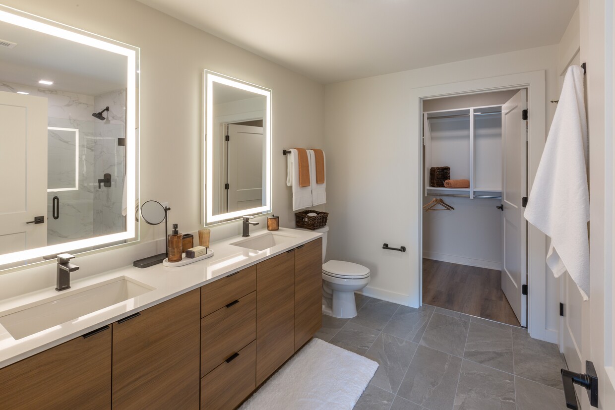 Backlit Vanity Mirror in All Bathrooms | A6 Wood Scheme | 1 Bedroom | 873 Sq. Ft. - Loria Ansley