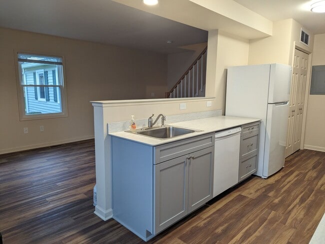 Another kitchen pic from eating counter looking into living room. Living room has one south facing w - 33 Falcon Ln W
