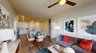 Located at 3200 W Colfax Ave in Denver, Colorado, this single-floor residence offers a thoughtfully designed open-concept layout that seamlessly connects the kitchen, dining, and living areas. The kitchen is a standout feature, showcasing white shaker cabinetry, quartz countertops, stainless steel appliances, a subway tile backsplash, and a large center island with pendant lighting and bar seating — ideal for both cooking and entertaining. Wood-look flooring runs throughout, adding warmth and continuity to the space. The dining area flows naturally from the kitchen, while the living room benefits from generous natural light through large windows with horizontal blinds and is finished with a ceiling fan overhead. Built-in shelving adds a practical and decorative touch near the living space. The bedroom is a serene retreat, featuring a ceiling fan, wide windows with outdoor views, and ample room for a full furniture arrangement. Two bathrooms serve the space: one with a sleek walk-in shower, a wide vanity with under-mount sink, and access to a walk-in closet; the other with a classic soaking tub and tiled surround. The overall aesthetic is modern and cohesive, with neutral tones and contemporary finishes throughout.