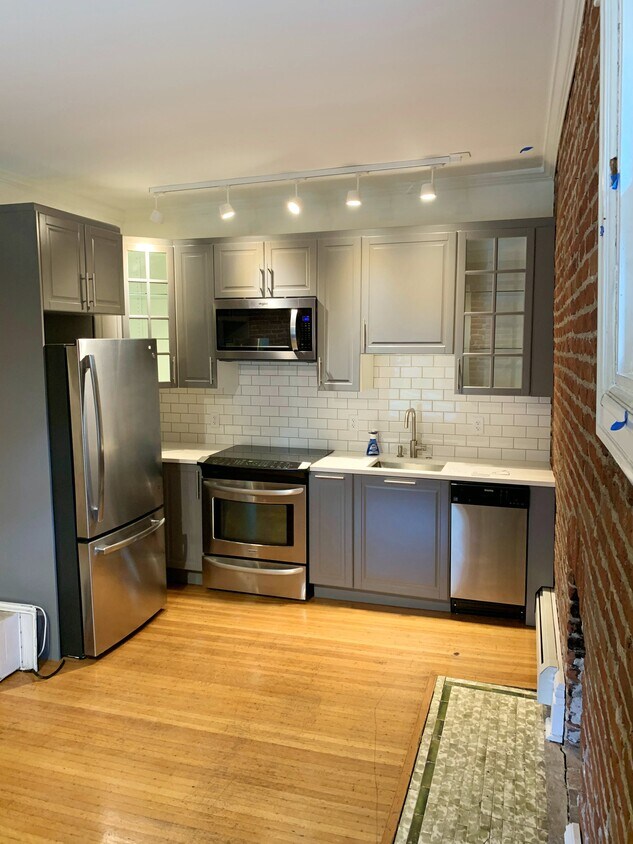 Bright kitchen offers stainless steel appliances, glass-face cabinets & granite countertops! - 1638 Adams St