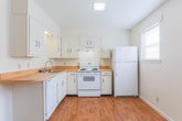 Located at 2125 Arbordale Pl in Dalton, Georgia, this two-floor residence offers a straightforward and functional layout designed for comfortable everyday living. The interior is finished with warm wood-look flooring throughout the main living and kitchen areas, while the bedrooms feature neutral-toned carpet underfoot.

The kitchen is well-equipped with ample white cabinetry providing generous storage, light-toned laminate countertops, a double-basin sink, and white appliances including a freestanding electric range and a full-size refrigerator. A window allows natural light to brighten the workspace.

The bedrooms are spacious and bright, each outfitted with ceiling fans with light fixtures and windows that invite natural light. At least one bedroom includes a walk-in closet, adding practical storage. The living area features carpet and a ceiling fan, with a front entry door visible nearby.

A bright hallway with wood-look flooring connects the main areas, leading toward a windowed front door that brings in additional daylight. The bathrooms include a vanity with white cabinetry and a large mirror, as well as a tub-shower combination. Clean white walls and neutral finishes are consistent throughout, giving the home a light, airy feel well-suited for a variety of furnishing styles.